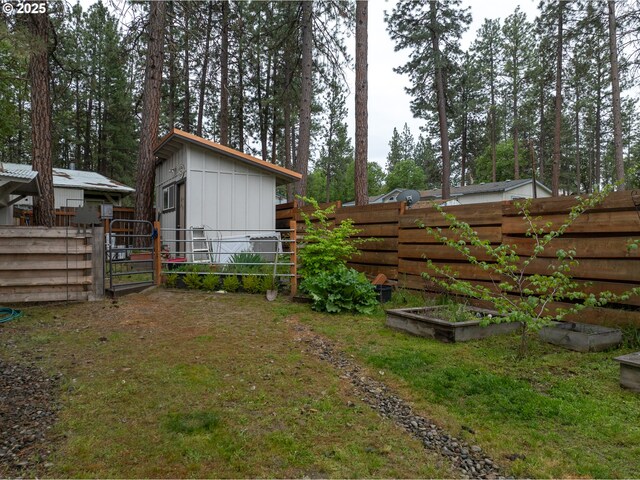 view of yard with a garden and a gate