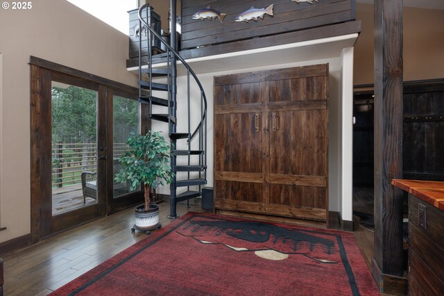 entryway featuring stairway and wood finished floors