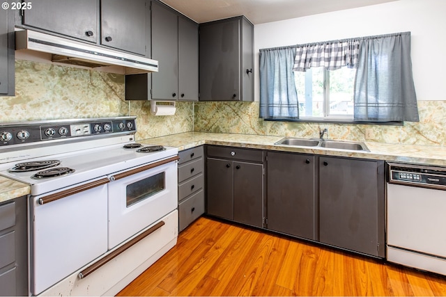 47508 Hansen St, Oakridge, OR 97463 - kitchen featuring white appliances, under cabinet range hood, a sink, and light countertops