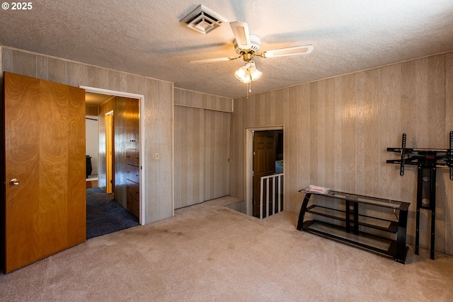 47508 Hansen St, Oakridge, OR 97463 - unfurnished bedroom with carpet flooring, a textured ceiling, wood walls, and a ceiling fan