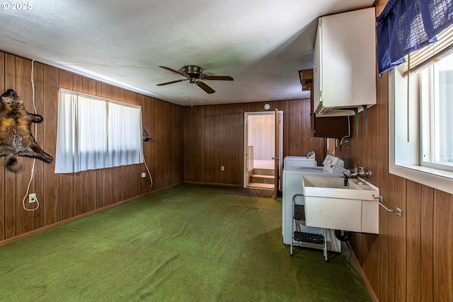 47508 Hansen St, Oakridge, OR 97463 - kitchen with separate washer and dryer, ceiling fan, brown cabinetry, wood walls, and a sink