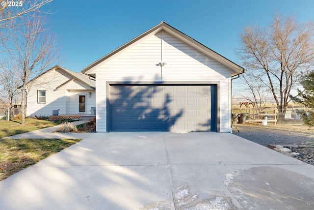 ranch-style house with a garage, concrete driveway, and fence