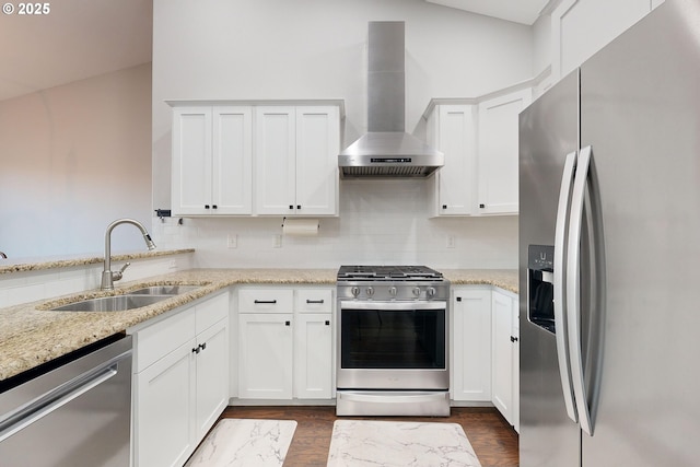 kitchen featuring wall chimney exhaust hood, white cabinetry, stainless steel appliances, and sink