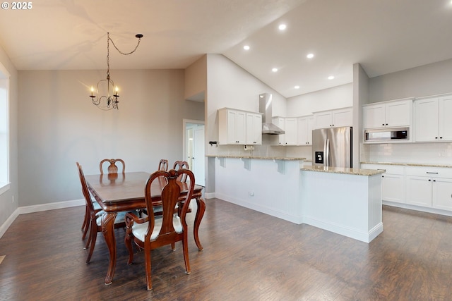 dining room with high vaulted ceiling, dark wood-type flooring, and a chandelier