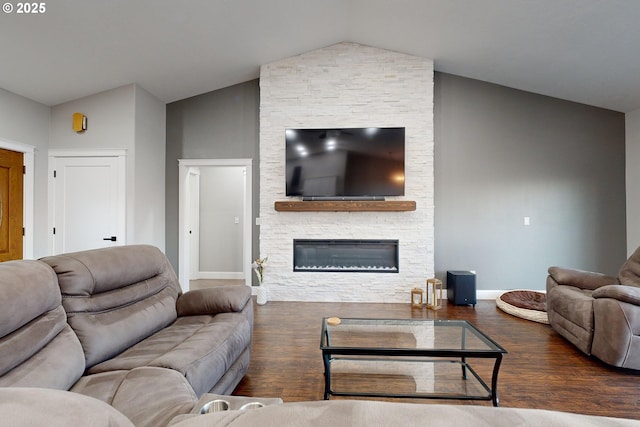 living room featuring dark wood-type flooring, a fireplace, and vaulted ceiling