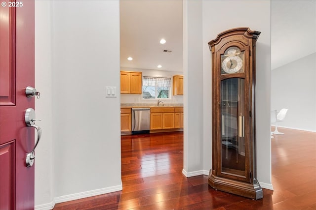 corridor featuring dark hardwood / wood-style flooring and sink