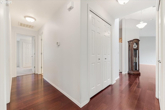 hallway with dark hardwood / wood-style floors