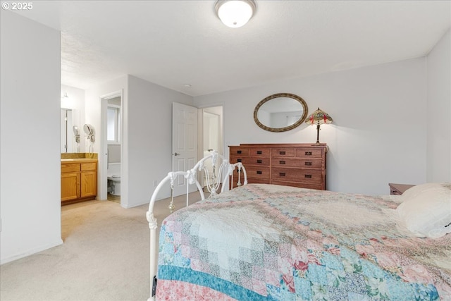 carpeted bedroom featuring connected bathroom and a textured ceiling