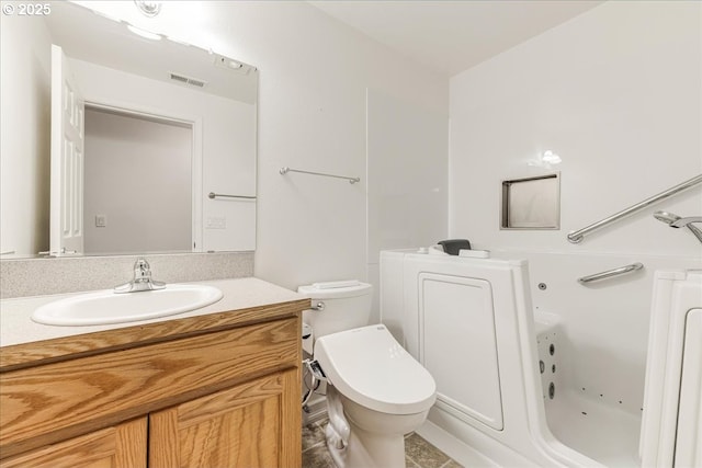 bathroom featuring vanity, toilet, and a bathing tub