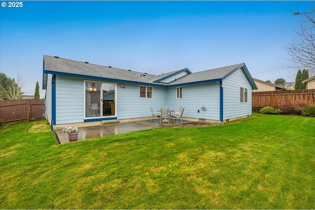 rear view of house with a patio and a yard