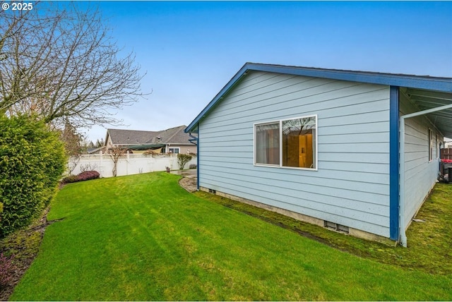 view of side of property with a lawn