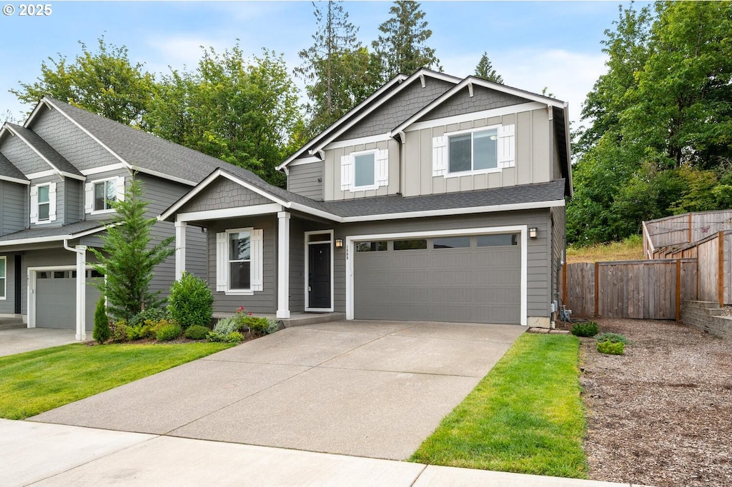 1809 NE 169th St, Ridgefield, WA 98642 - view of front of home featuring a garage, board and batten siding, fence, and concrete driveway