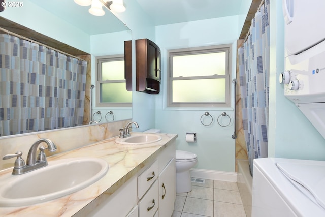 4296 SE Fieldcrest St, Milwaukie, OR 97222 - full bathroom with double vanity, tile patterned floors, and stacked washing machine and dryer