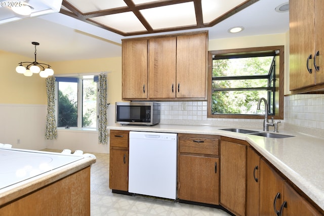 4296 SE Fieldcrest St, Milwaukie, OR 97222 - kitchen featuring white dishwasher, stainless steel microwave, light countertops, brown cabinetry, and light flooring