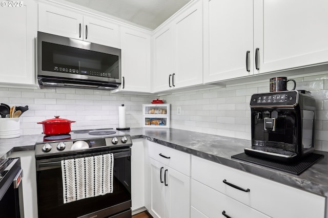 kitchen featuring white cabinetry, appliances with stainless steel finishes, and backsplash