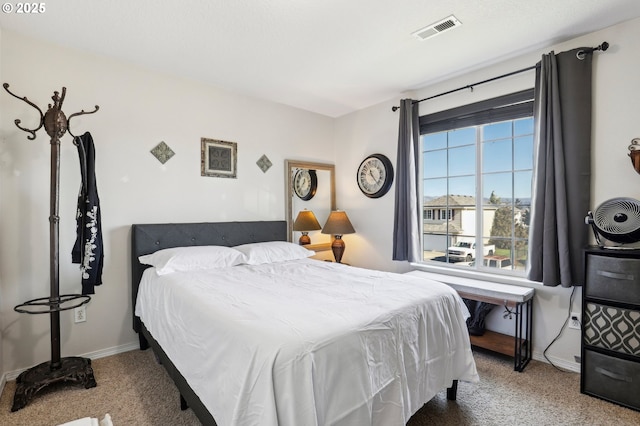 bedroom with carpet, visible vents, and baseboards