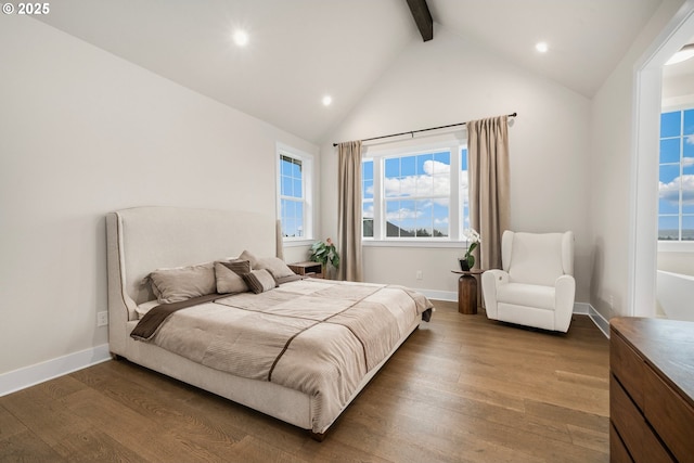 bedroom with beam ceiling, baseboards, and wood finished floors