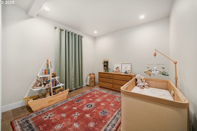 bedroom featuring baseboards, wood finished floors, and recessed lighting