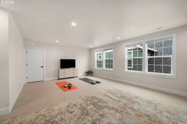 unfurnished living room with baseboards, recessed lighting, visible vents, and light colored carpet