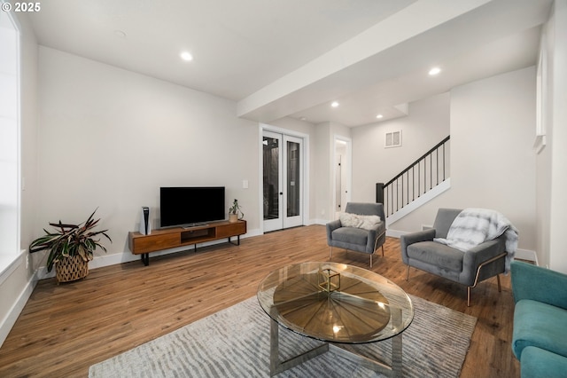 living area featuring stairs, recessed lighting, french doors, and wood finished floors