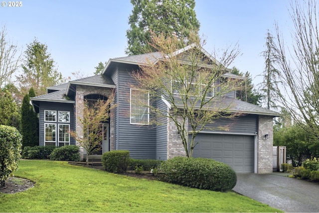 view of front of house featuring a front yard, an attached garage, brick siding, and driveway