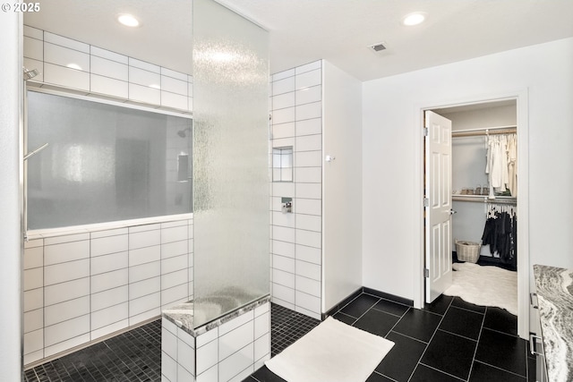 full bath with visible vents, recessed lighting, a spacious closet, a walk in shower, and tile patterned floors