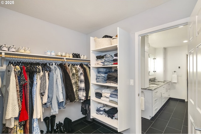 spacious closet featuring dark tile patterned floors