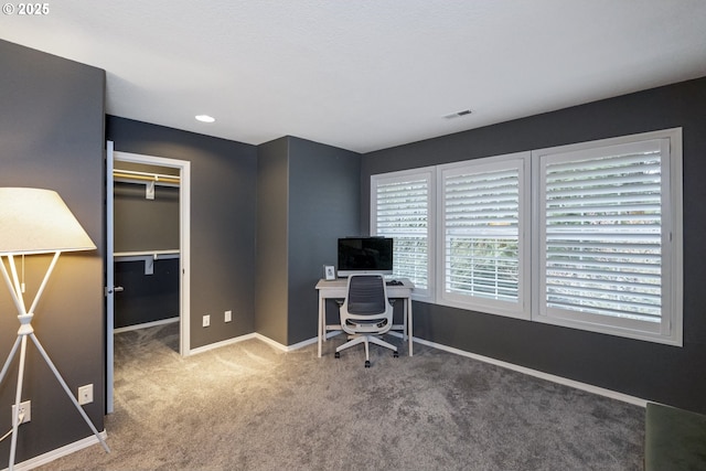 office space with visible vents, baseboards, and carpet flooring