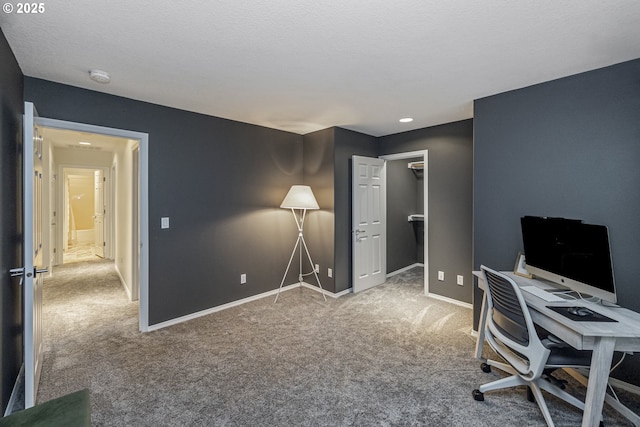 carpeted office space featuring baseboards