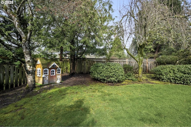 view of yard with an outbuilding and a fenced backyard