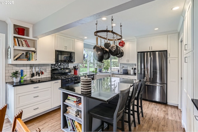 1543 NE Hyde St, Hillsboro, OR 97124 - kitchen featuring black appliances, open shelves, dark countertops, and recessed lighting