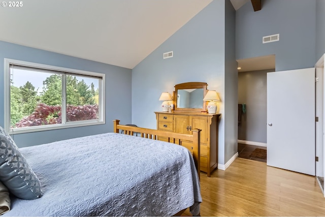 1543 NE Hyde St, Hillsboro, OR 97124 - bedroom featuring high vaulted ceiling, light wood finished floors, and baseboards