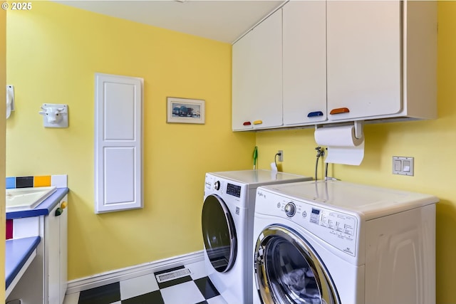 1543 NE Hyde St, Hillsboro, OR 97124 - laundry area with cabinet space, washing machine and clothes dryer, baseboards, and light floors