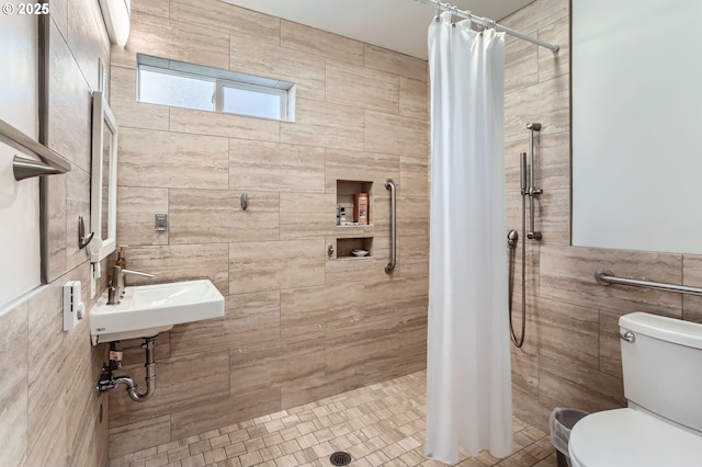 1543 NE Hyde St, Hillsboro, OR 97124 - full bathroom featuring tile walls, a shower stall, toilet, a sink, and tile patterned floors