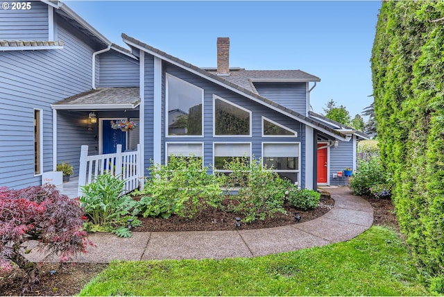 1543 NE Hyde St, Hillsboro, OR 97124 - view of side of property with a chimney and a shingled roof