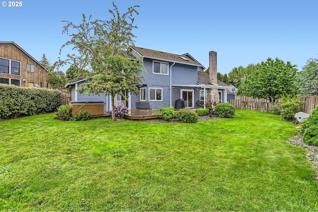 1543 NE Hyde St, Hillsboro, OR 97124 - back of house featuring a hot tub, a chimney, and a wooden deck