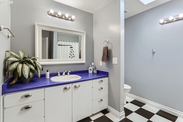 1543 NE Hyde St, Hillsboro, OR 97124 - bathroom featuring tile patterned floors, vanity, toilet, and baseboards