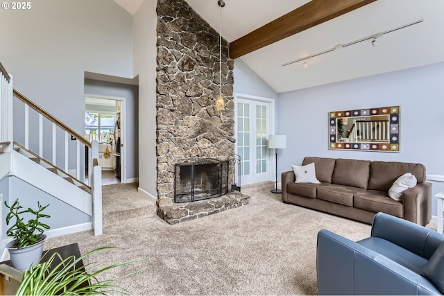 1543 NE Hyde St, Hillsboro, OR 97124 - carpeted living room with track lighting, stairs, a fireplace, beam ceiling, and high vaulted ceiling