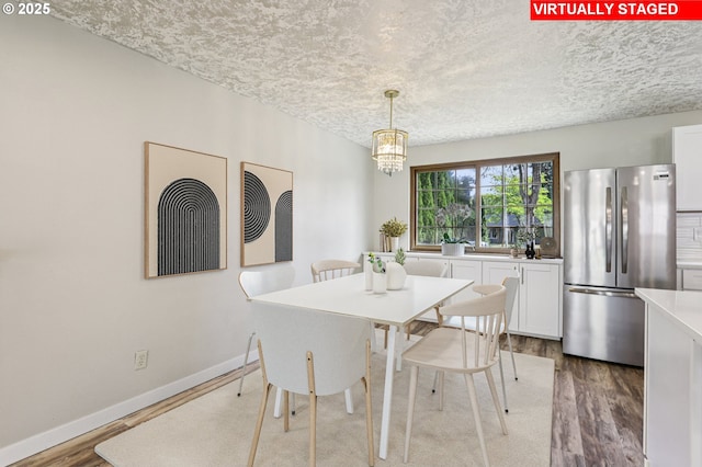 1213 NW Westridge St, Vancouver, WA 98665 - dining room with wood finished floors, a textured ceiling, and a chandelier