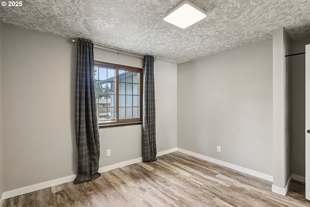1213 NW Westridge St, Vancouver, WA 98665 - spare room with wood finished floors and a textured ceiling