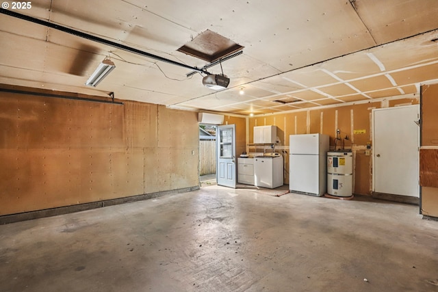 1213 NW Westridge St, Vancouver, WA 98665 - garage with freestanding refrigerator, a garage door opener, washer and dryer, and secured water heater