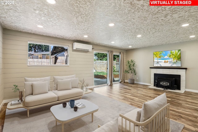 1213 NW Westridge St, Vancouver, WA 98665 - living room with a wall mounted air conditioner, wood finished floors, recessed lighting, a brick fireplace, and wooden walls