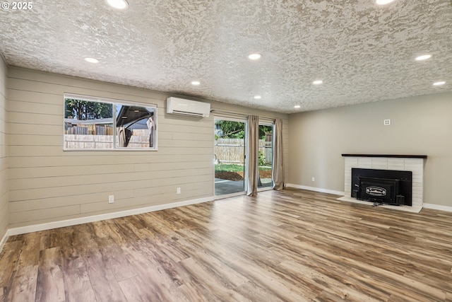 1213 NW Westridge St, Vancouver, WA 98665 - unfurnished living room featuring a wall mounted AC, wood finished floors, a brick fireplace, recessed lighting, and wood walls