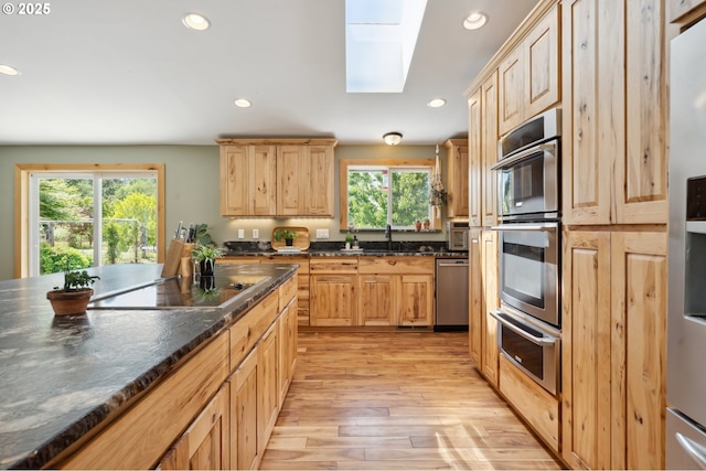 40774 SE Trubel Rd, Sandy, OR 97055 - kitchen with appliances with stainless steel finishes, a skylight, a warming drawer, light brown cabinets, and light wood-style floors