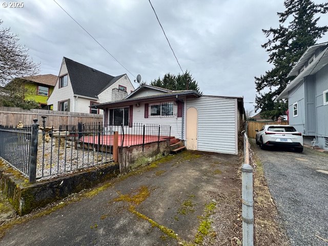 view of front of home with fence and aphalt driveway