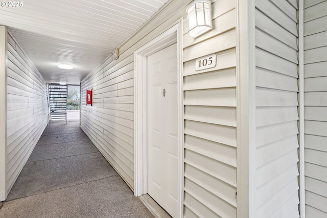 hall featuring wood walls