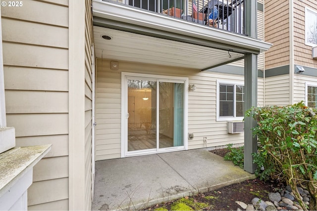 entrance to property featuring a patio area and a balcony