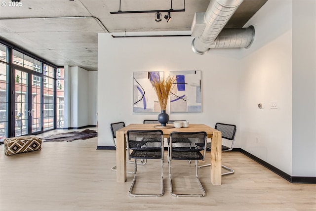 dining room featuring baseboards and wood finished floors