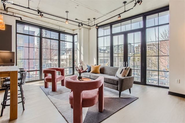 sunroom with rail lighting and a healthy amount of sunlight