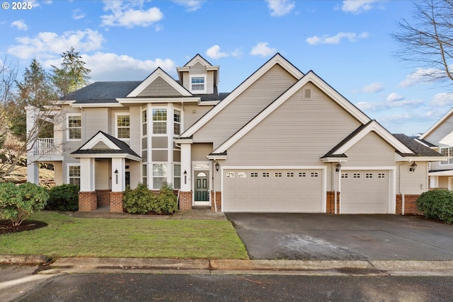 craftsman-style home with a garage and a front lawn